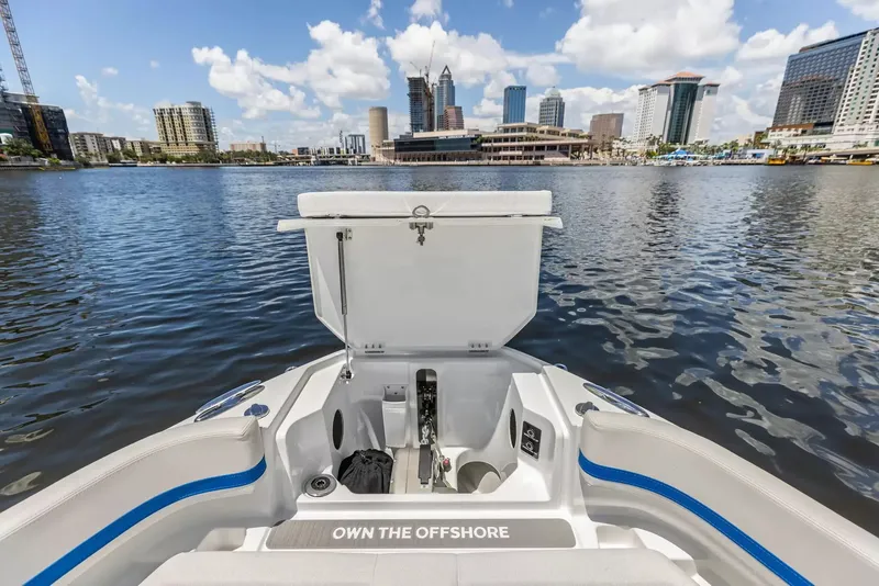 Slide: The Image of The image shows the bow of a Wellcraft 28 Explorer boat with a city skyline in the background. - 33