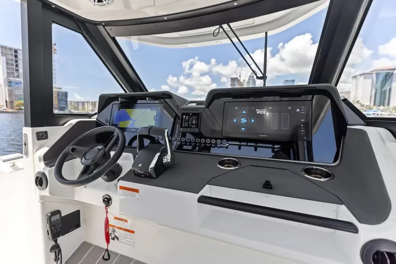 Slide: The Image of The cockpit of the 2027 Wellcraft 28 Explorer features modern navigation systems and controls. - 16