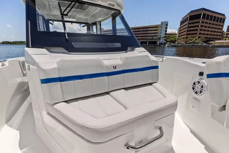 Slide: The Image of The image shows the cockpit of a 2027 Wellcraft 28 Explorer with white upholstery and blue accents. - 28