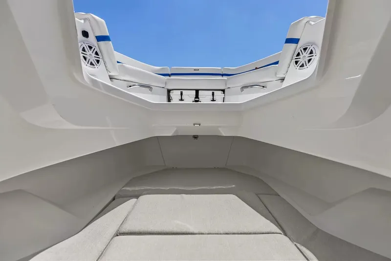 Slide: The Image of The image shows the interior of a 2027 Wellcraft 28 Explorer boat with white upholstery. - 26
