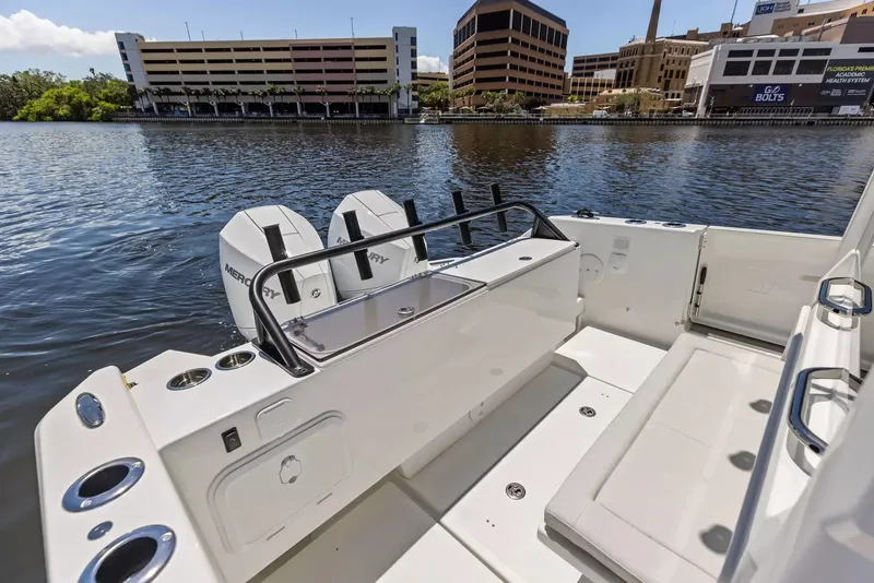 Slide: The Image of The image shows a modern boat with twin outboard engines docked in an urban harbor. - 8