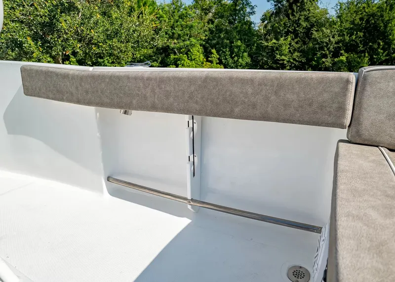Slide: The Image of The image shows a cushioned bench seat on a boat, surrounded by lush greenery in the background. - 6