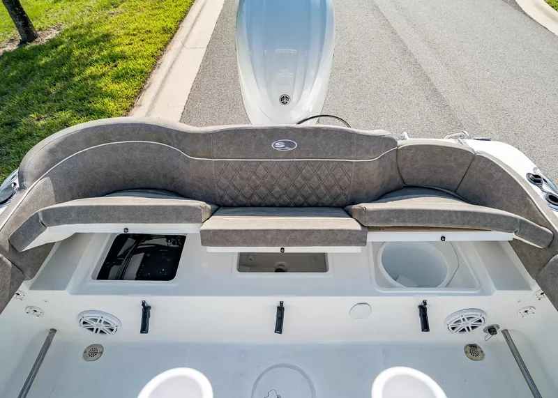 Slide: The Image of The image shows the stern of a Sea Hunt Ultra 229 boat with gray cushions and speakers. - 10