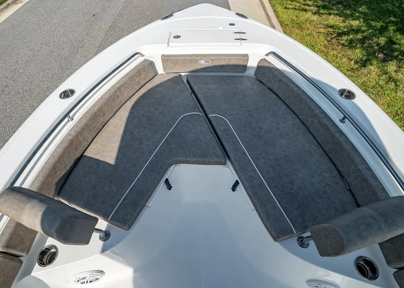 Slide: The Image of The image shows the bow of a Sea Hunt Ultra 229 with gray cushions and white accents. - 19