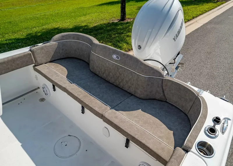 Slide: The Image of The 2027 Sea Hunt Ultra 229 features a sleek, cushioned bench seat with a Yamaha engine in the background. - 5