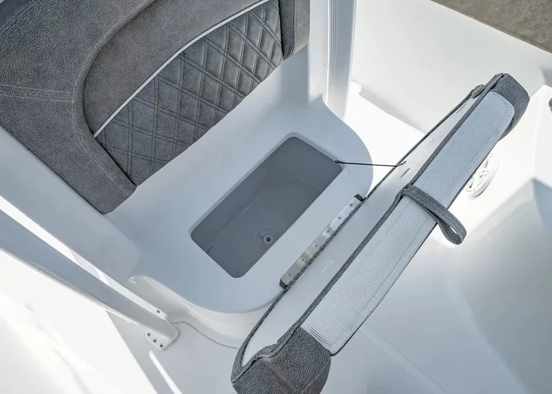 Slide: The Image of A gray boat seat with a flip-up cushion revealing storage space underneath. - 18