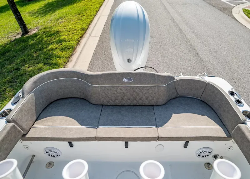 Slide: The Image of The image shows the stern of a Sea Hunt Ultra 229 boat with gray cushions and speakers. - 4
