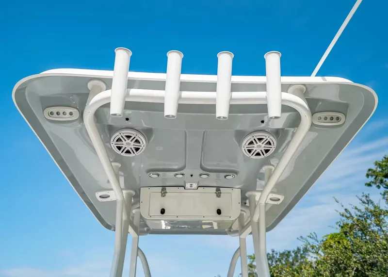 Slide: The Image of The image shows the T-top of a Sea Hunt Ultra 229 boat with speakers and rod holders. - 8