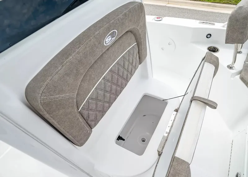 Slide: The Image of The image shows the seating area of a Sea Hunt BX25FS boat with gray upholstery and a storage compartment. - 20