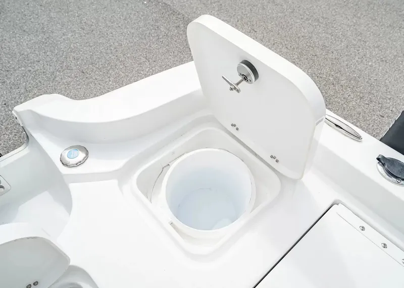 Slide: The Image of An open storage compartment on a 2027 Sea Hunt BX25FS boat. - 9