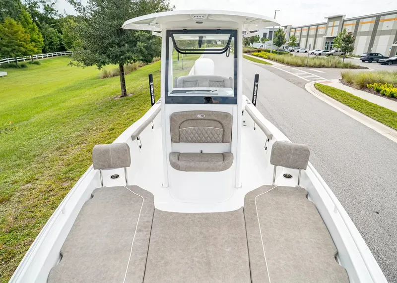 Slide: The Image of The image shows a 2027 Sea Hunt BX25FS boat with a spacious deck and cushioned seating. - 19