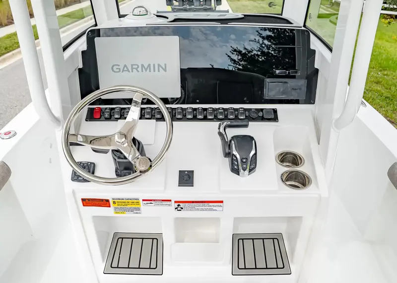 Slide: The Image of The image shows the helm of a Sea Hunt BX25FS boat with a Garmin display. - 13