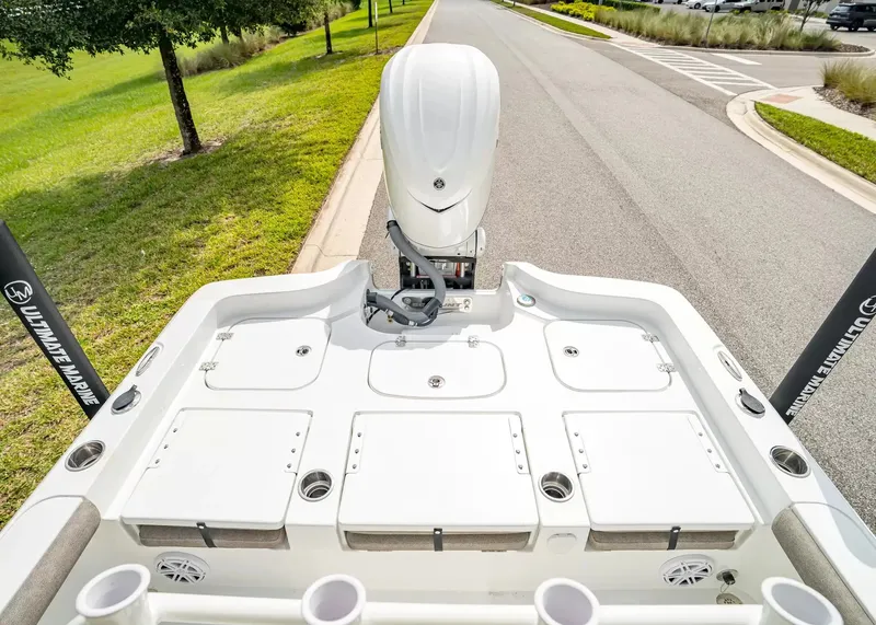 Slide: The Image of The image shows the stern of a 2027 Sea Hunt BX25FS boat parked on a road. - 4