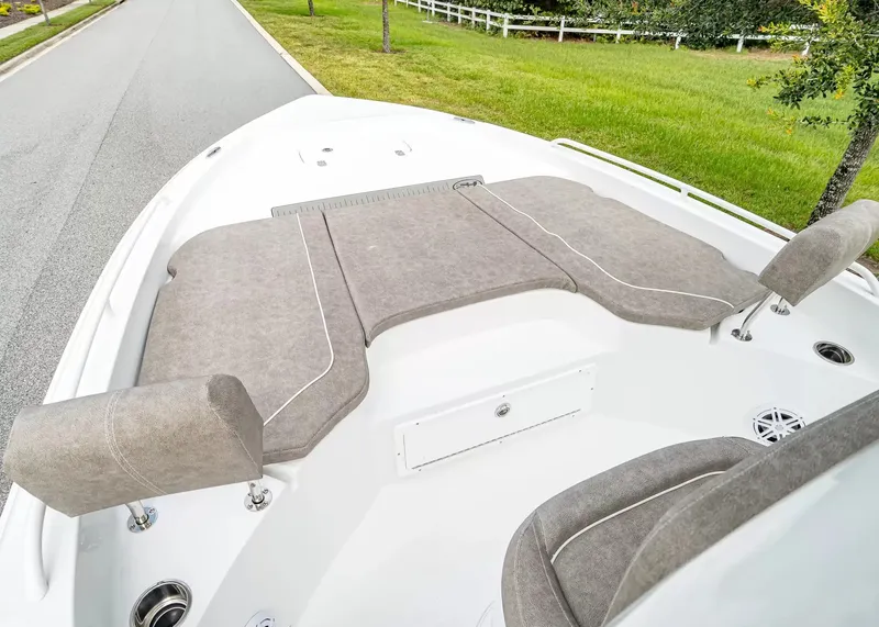 Slide: The Image of The image shows the bow of a 2027 Sea Hunt BX25FS boat with gray cushions. - 17