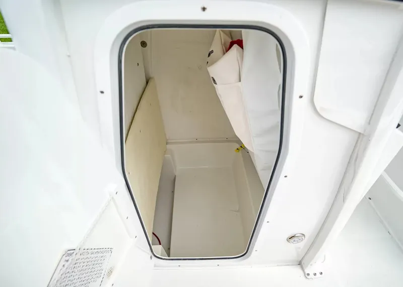 Slide: The Image of A view into a storage compartment or cabin of a 2027 Sea Hunt BX25FS boat. - 16