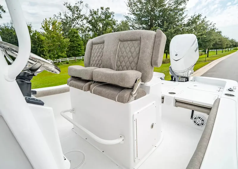 Slide: The Image of The image shows the cockpit of a Sea Hunt BX25FS boat with cushioned seats and a helm station. - 15