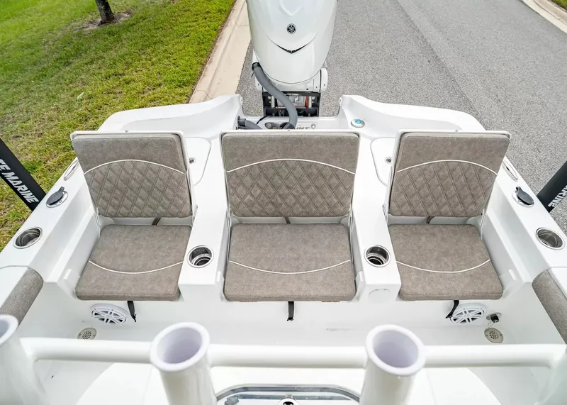 Slide: The Image of The image shows the rear seats of a Sea Hunt BX25FS boat with gray cushions and cup holders. - 6