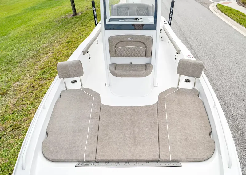 Slide: The Image of The image shows the deck of a 2027 Sea Hunt BX25FS boat with cushioned seating. - 18