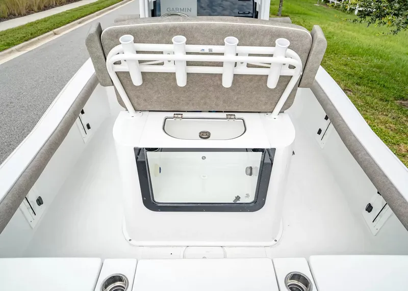 Slide: The Image of The image shows the cockpit of a 2027 Sea Hunt BX25FS boat with rod holders and storage. - 10