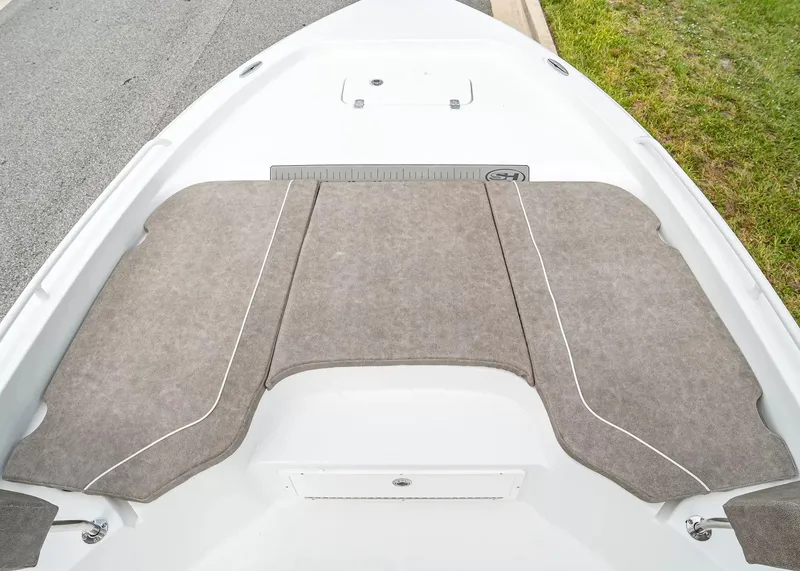 Slide: The Image of The image shows the bow deck of a 2027 Sea Hunt BX25FS boat with cushioned seating. - 21