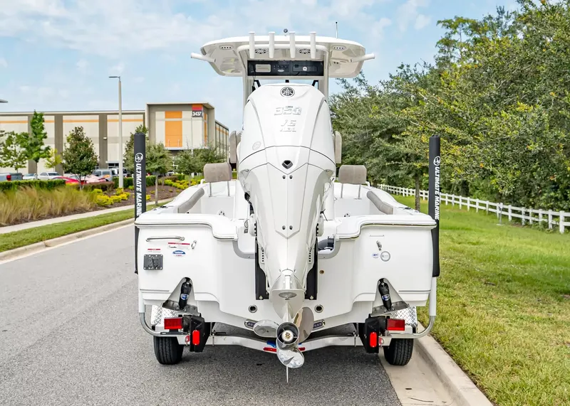 Slide: The Image of The image shows a 2027 Sea Hunt BX25FS boat on a trailer, parked on a street. - 3