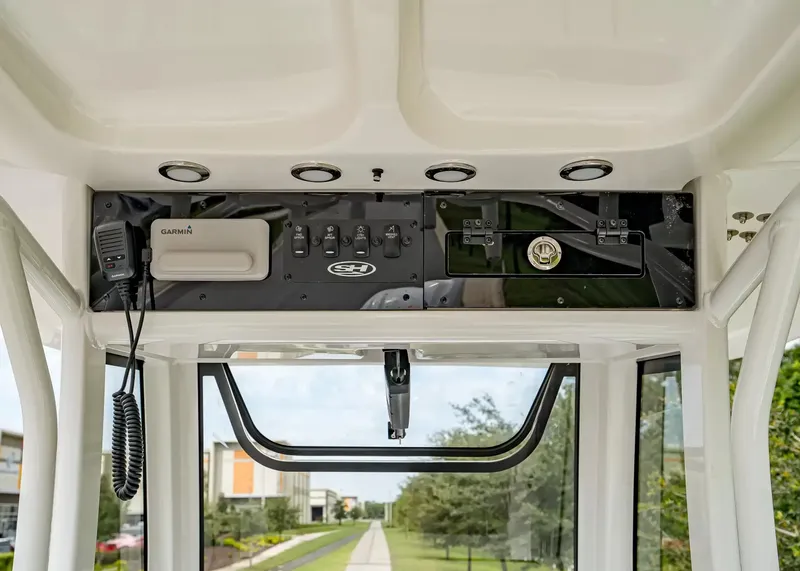 Slide: The Image of The image shows the helm of a 2027 Sea Hunt BX25FS boat with electronics and controls. - 12