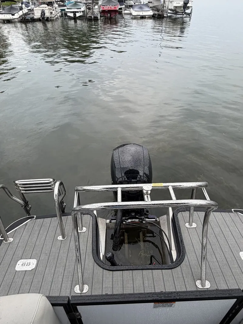 Slide: The Image of The image shows the stern of a 2023 Sylvan Mirage X X1 boat with an outboard motor. - 6