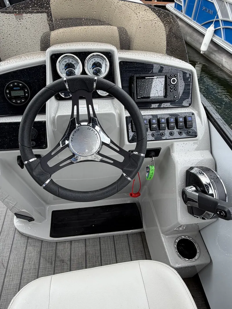 Slide: The Image of The image shows the helm of a 2023 Sylvan Mirage X X1 with modern instruments. - 5