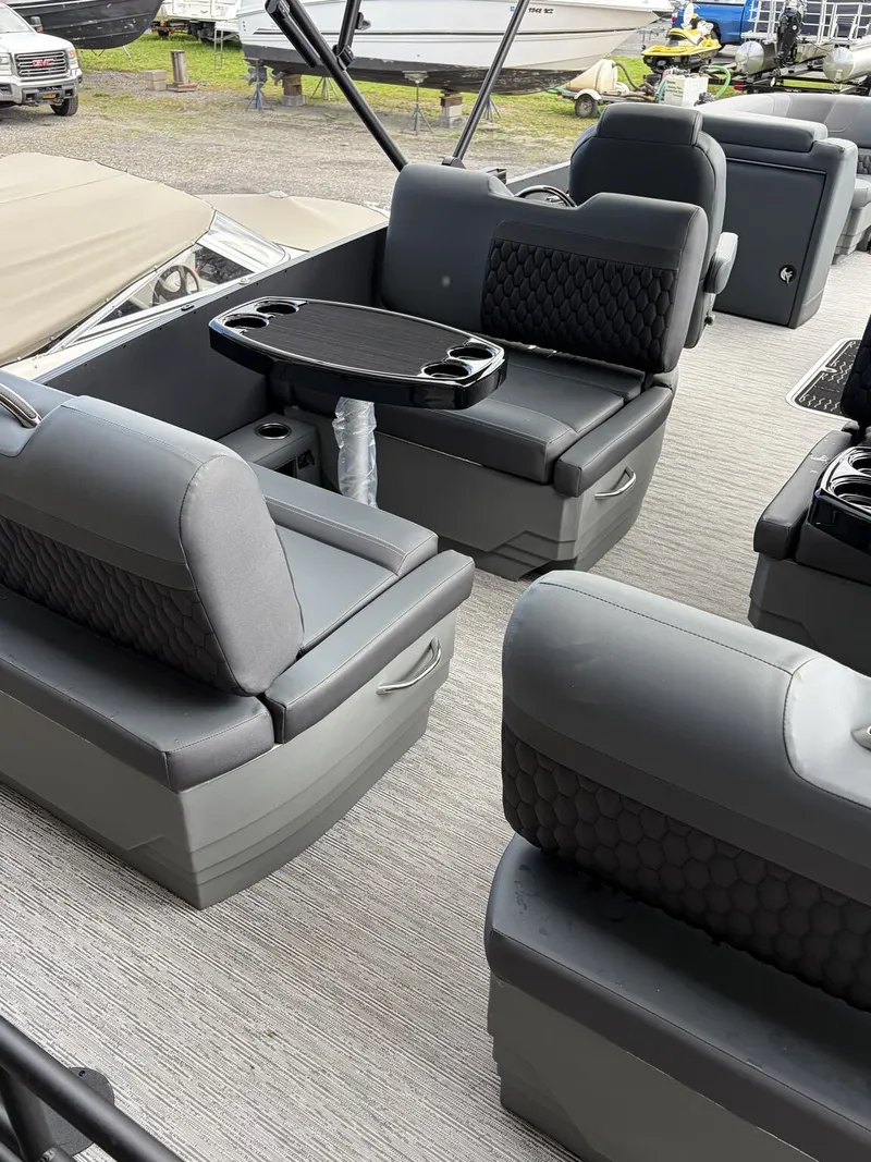 Slide: The Image of The image shows the interior of a 2027 Sylvan L3 RLZ Platinum with gray seating and a table. - 5