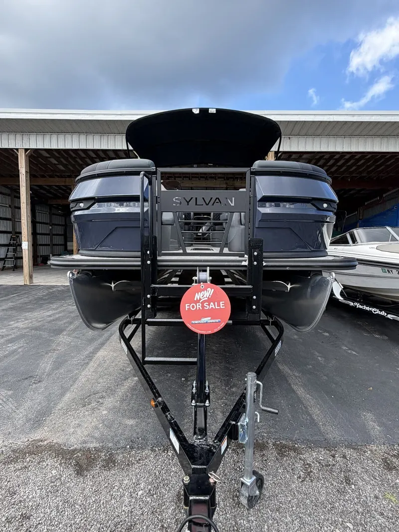 Slide: The Image of A 2027 Sylvan L3 RLZ Platinum pontoon boat on a trailer with a 'For Sale' sign. - 2