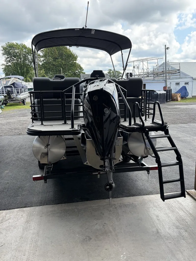 Slide: The Image of The image shows a 2027 Sylvan L3 RLZ Platinum pontoon boat with an outboard motor and swim ladder. - 4