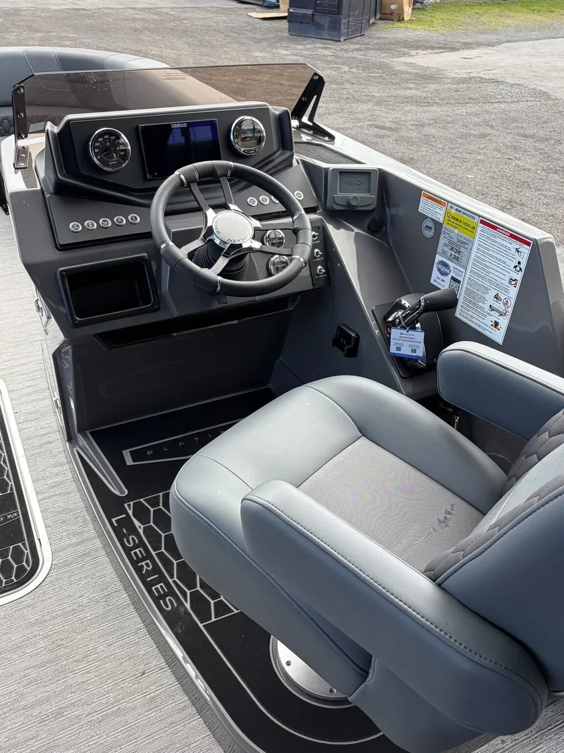 Slide: The Image of The image shows the cockpit of a 2027 Sylvan L3 RLZ Platinum with a modern helm. - 8