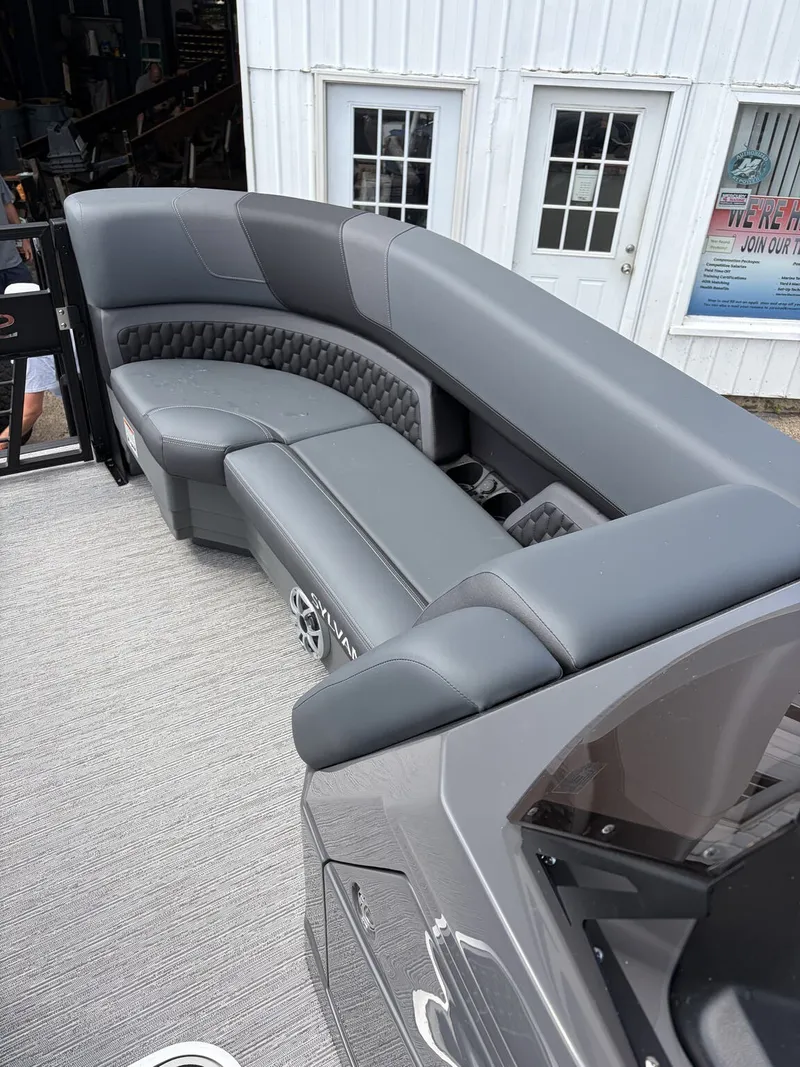 Slide: The Image of The image shows a luxurious gray seating area on a boat, surrounded by a modern setting. - 12