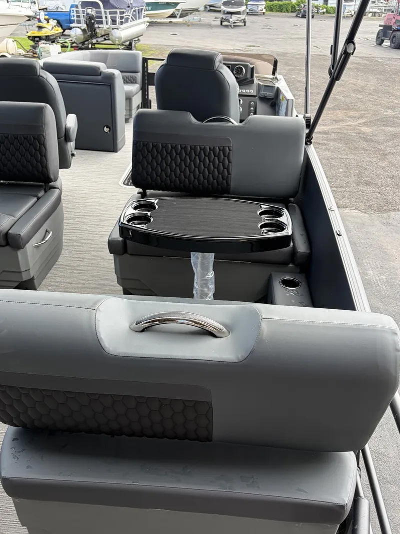 Slide: The Image of The image shows the interior of a 2027 Sylvan L3 RLZ Platinum with gray seating and a table. - 6