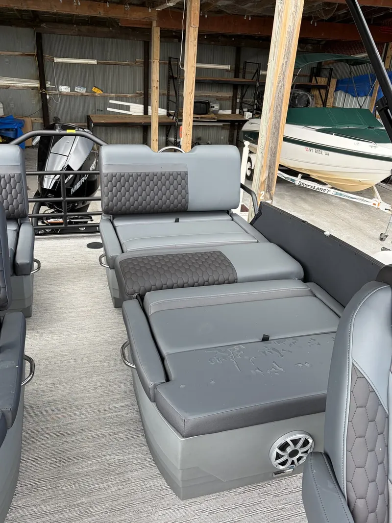 Slide: The Image of The image shows the interior of a 2027 Sylvan L3 RLZ Platinum. There are gray, cushioned seats with a modern design and a speaker on the side. - 9