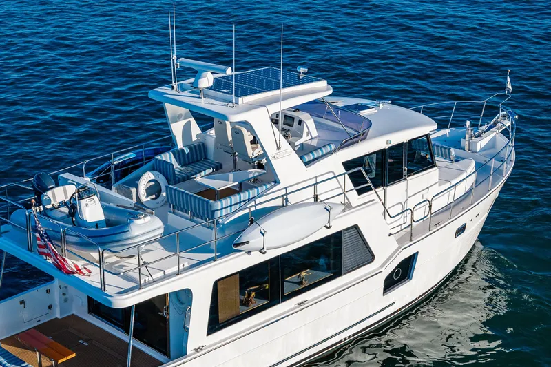 Slide: The Image of 2023 North Pacific 53 Euro yacht cruising on open water, showcasing sleek design and spacious deck. - 95
