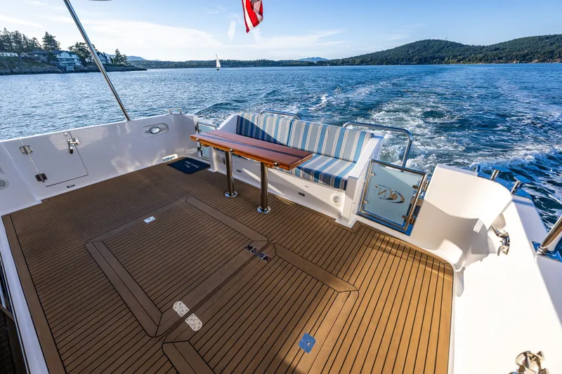 Slide: The Image of Luxurious 2023 North Pacific 53 Euro yacht deck with seating, cruising on scenic waters. - 68