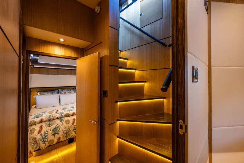 Slide: The Image of Luxurious interior of 2023 North Pacific 53 Euro yacht with illuminated stairs and cozy bedroom. - 30