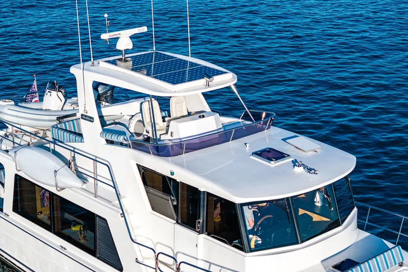 Slide: The Image of 2023 North Pacific 53 Euro yacht cruising on blue water, featuring solar panels and modern design. - 85