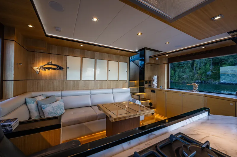 Slide: The Image of Luxurious interior of 2023 North Pacific 53 Euro yacht with elegant seating and scenic window view. - 19