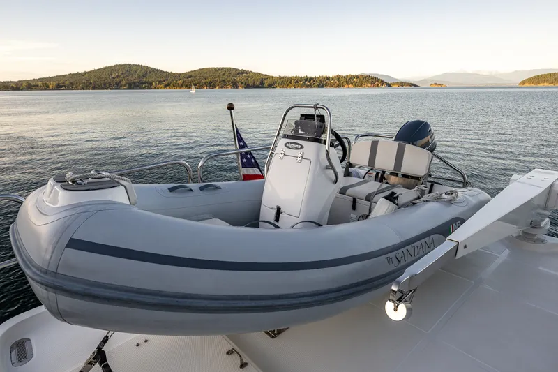 Slide: The Image of 2023 North Pacific 53 Euro yacht with inflatable boat on deck, scenic water view. - 59