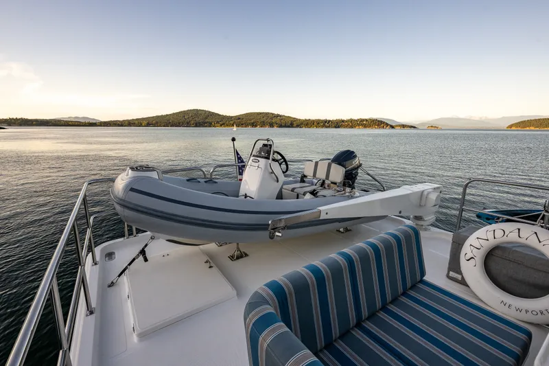 Slide: The Image of 2023 North Pacific 53 Euro yacht deck with scenic ocean view and inflatable boat. - 58