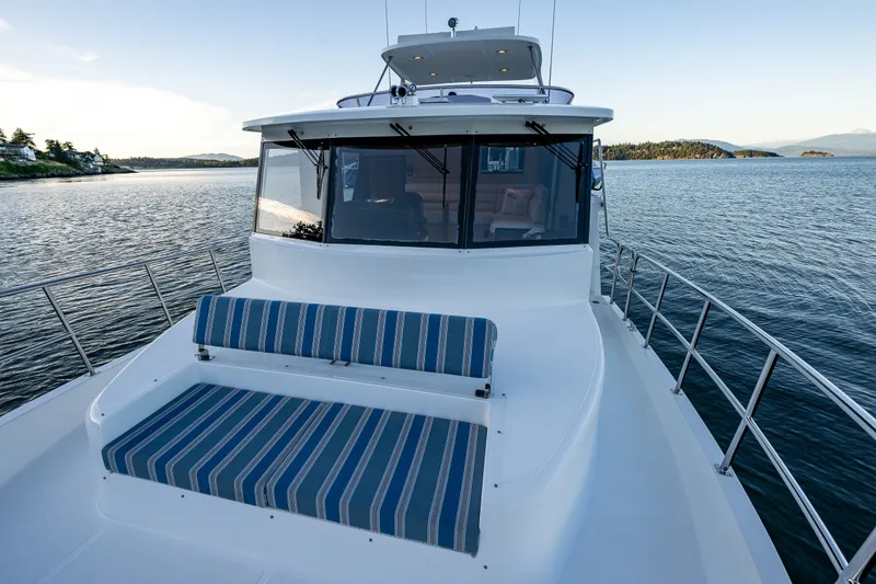 Slide: The Image of 2023 North Pacific 53 Euro yacht with striped seating, cruising on calm waters. - 61