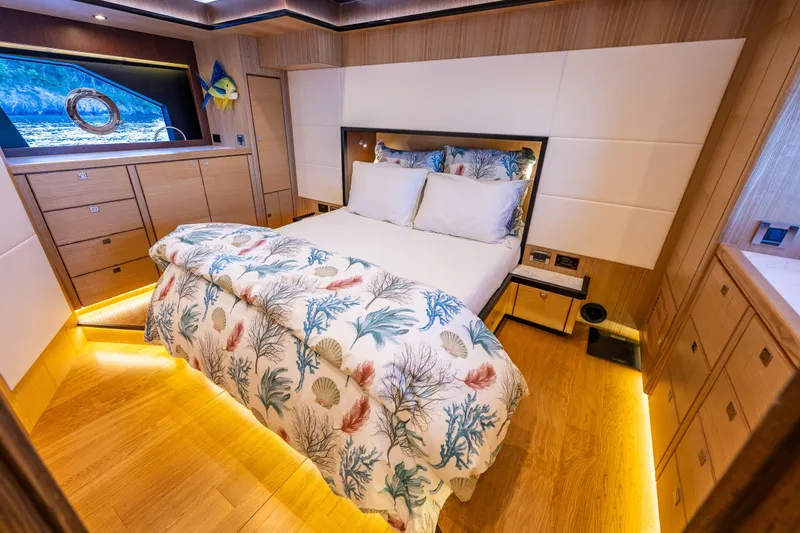 Slide: The Image of Luxurious 2023 North Pacific 53 Euro yacht bedroom with elegant decor and ambient lighting. - 33