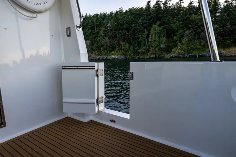 Slide: The Image of 2023 North Pacific 53 Euro yacht deck with scenic water and forest view. - 72
