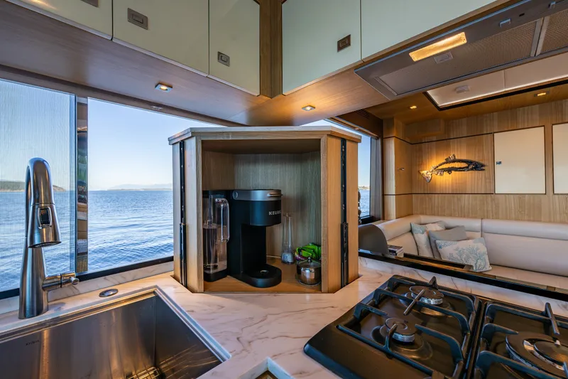 Slide: The Image of Luxurious 2023 North Pacific 53 Euro yacht kitchen with ocean view and modern amenities. - 11