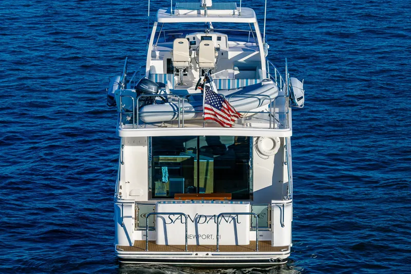 Slide: The Image of 2023 North Pacific 53 Euro yacht on blue ocean, rear view with American flag. - 2