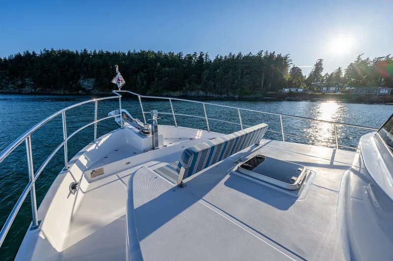 Slide: The Image of Bow view of 2023 North Pacific 53 Euro yacht cruising near forested shoreline. - 63