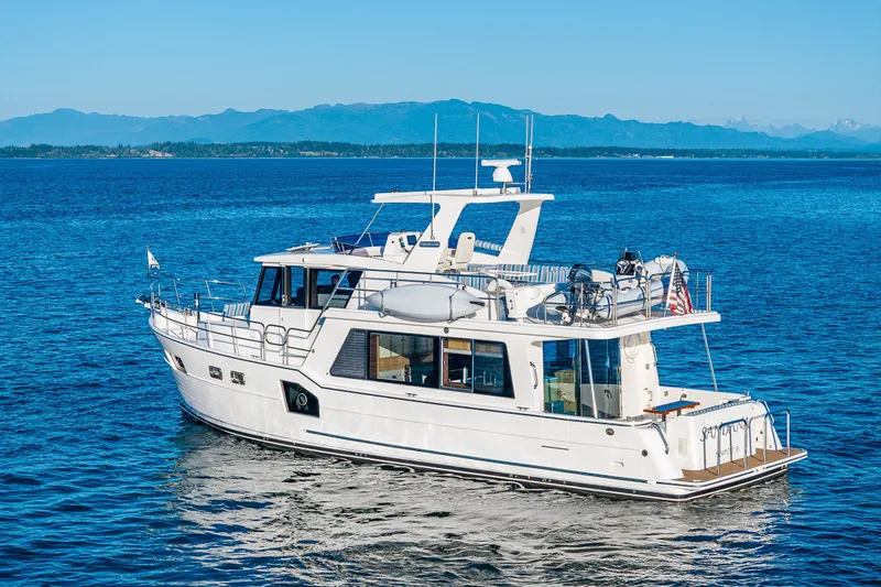 Slide: The Image of 2023 North Pacific 53 Euro yacht cruising on a serene blue ocean. - 100