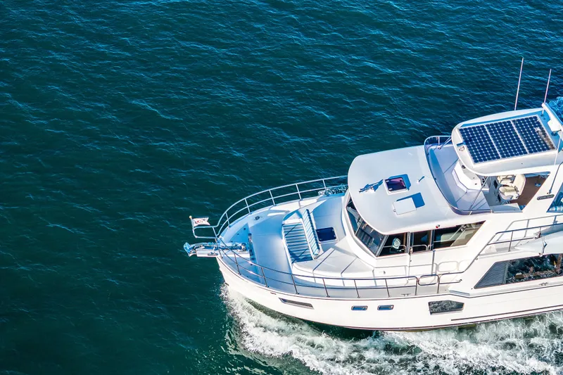 Slide: The Image of 2023 North Pacific 53 Euro yacht cruising on open water, featuring solar panels. - 83